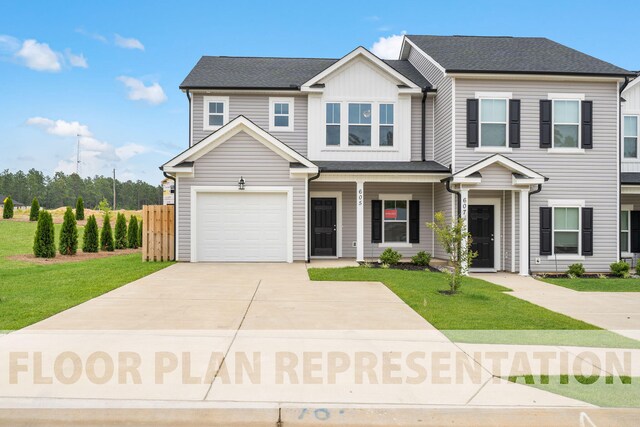 view of front of home featuring a garage and a front lawn