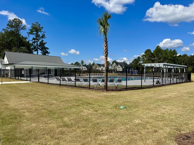 view of pool with a yard and a pergola