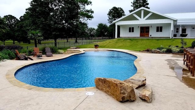 view of swimming pool with a lawn and a patio area