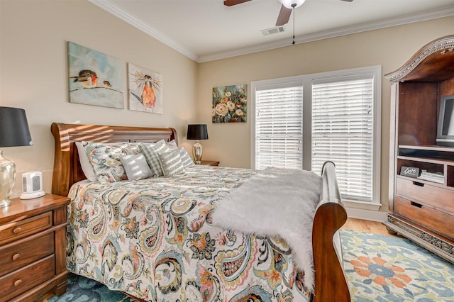 bedroom with hardwood / wood-style floors, ceiling fan, and crown molding