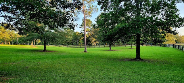 view of community featuring a yard and a rural view