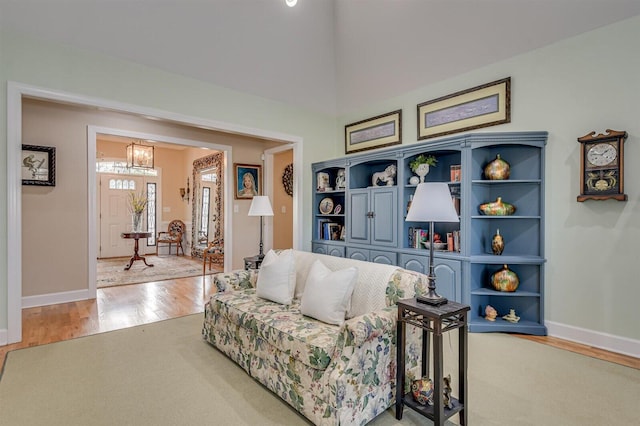 living room with hardwood / wood-style flooring and a high ceiling