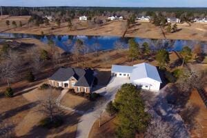 birds eye view of property with a water view