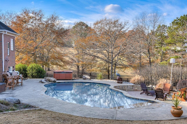 view of swimming pool featuring a patio and a hot tub