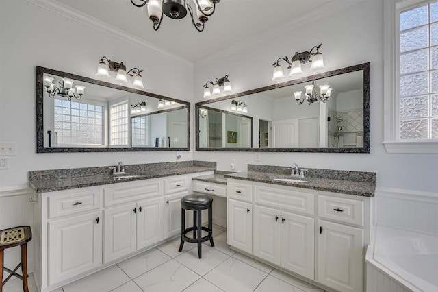 bathroom featuring vanity, ornamental molding, and a notable chandelier