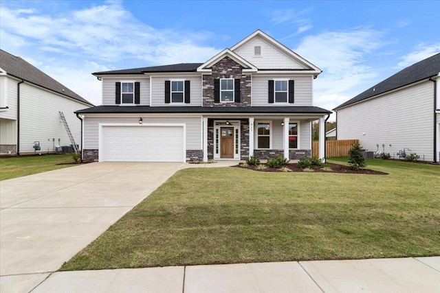 craftsman house featuring central air condition unit, a front lawn, a porch, and a garage