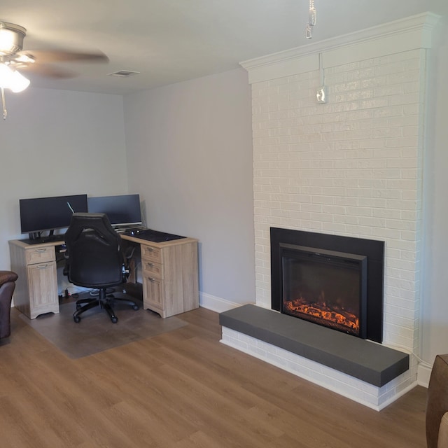 3597 Parliament Pl, Martinez, GA 30907 - home office featuring wood finished floors, a ceiling fan, and a fireplace