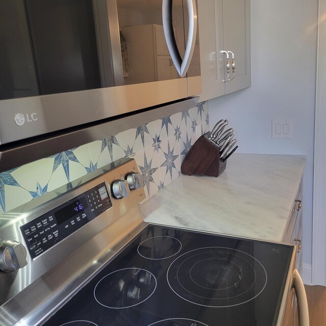 3597 Parliament Pl, Martinez, GA 30907 - kitchen view of appliances with stainless steel finishes, backsplash, and light countertops
