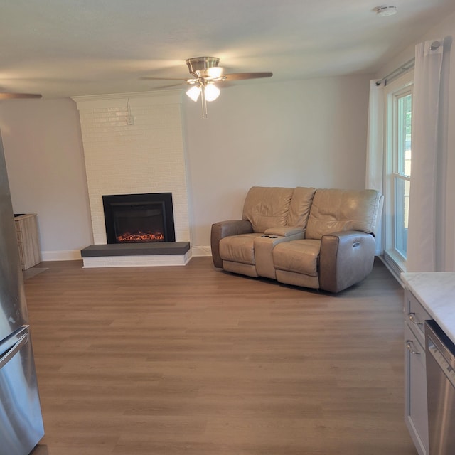 3597 Parliament Pl, Martinez, GA 30907 - living room featuring a ceiling fan, light wood-style floors, and a fireplace