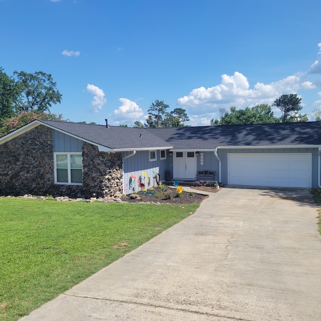 3597 Parliament Pl, Martinez, GA 30907 - view of front of house featuring board and batten siding, a garage, driveway, and a front yard