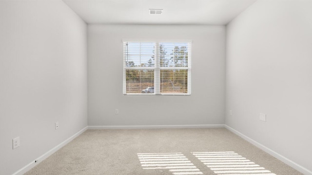 carpeted empty room with baseboards and visible vents
