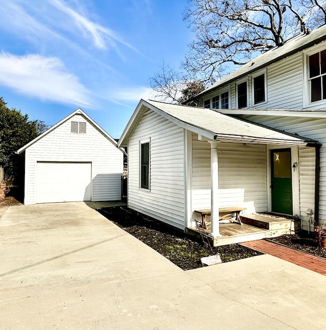 view of side of home featuring a garage and an outdoor structure