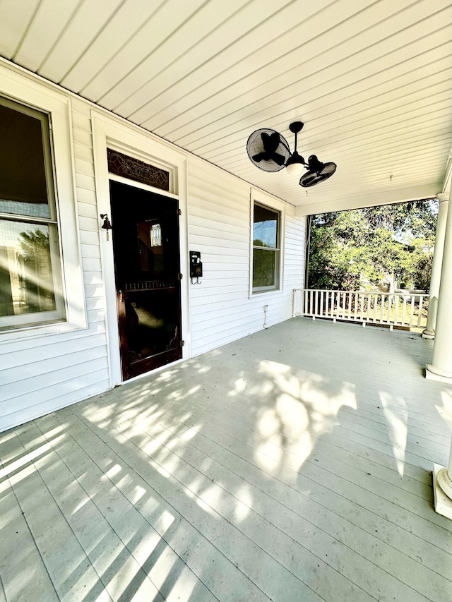 exterior space with ceiling fan and a porch