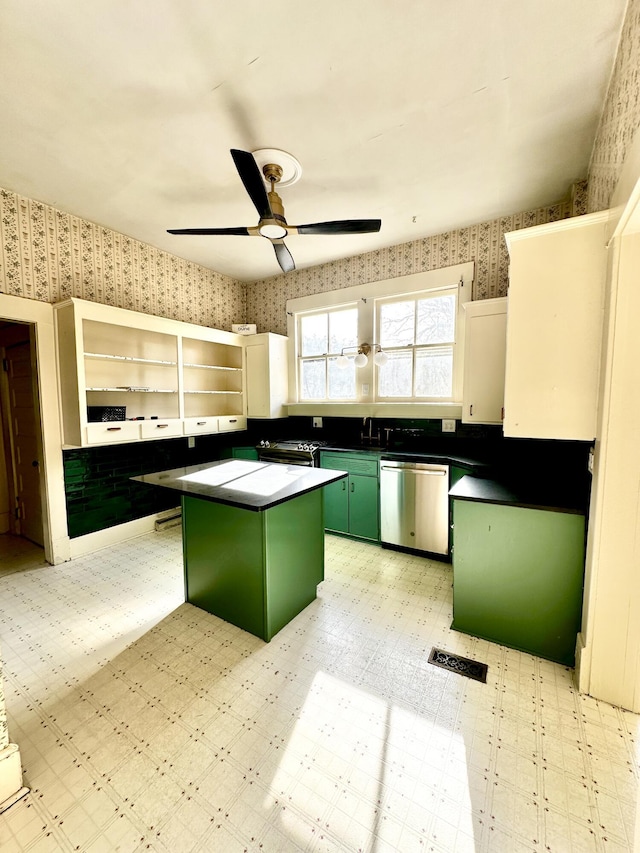 kitchen with a kitchen island, ceiling fan, green cabinetry, dishwasher, and white cabinetry