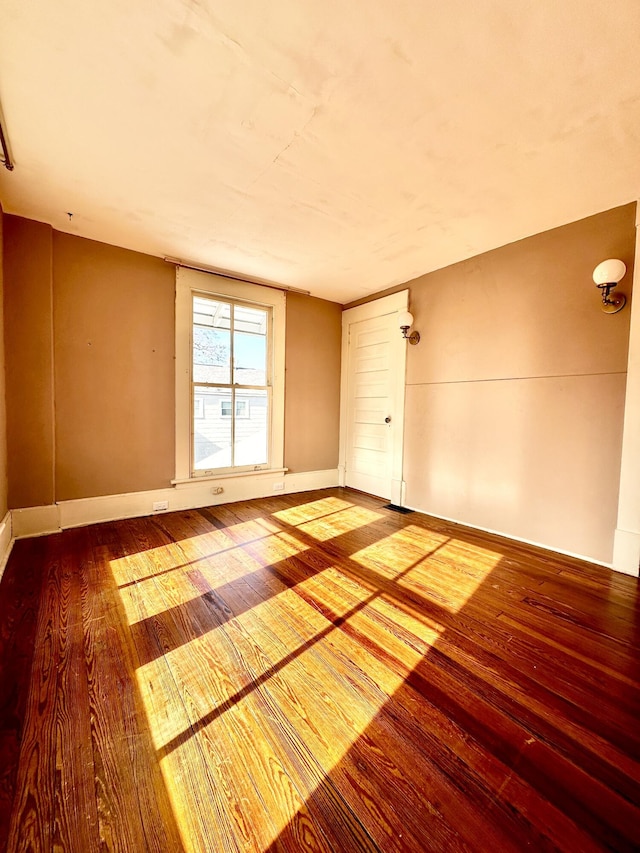 unfurnished room featuring hardwood / wood-style flooring