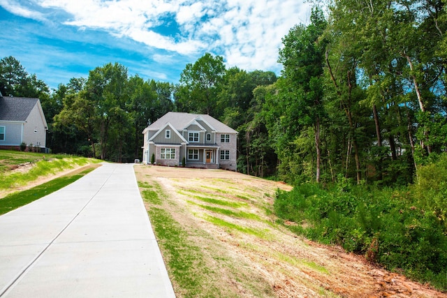 view of front of home with a front yard, board and batten siding, and driveway