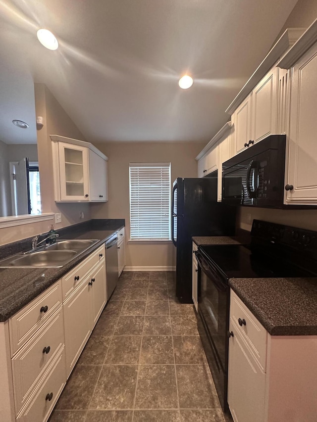 kitchen featuring white cabinetry, dark tile patterned floors, sink, and black appliances