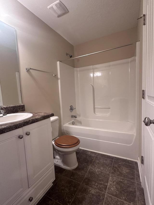 full bathroom with vanity, a textured ceiling, toilet, and shower / bath combination