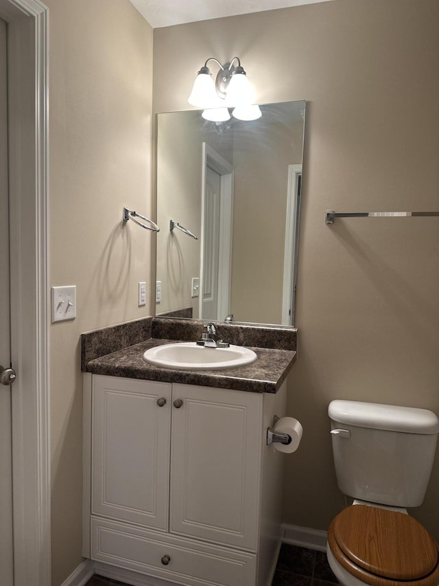 bathroom with vanity, tile patterned flooring, and toilet