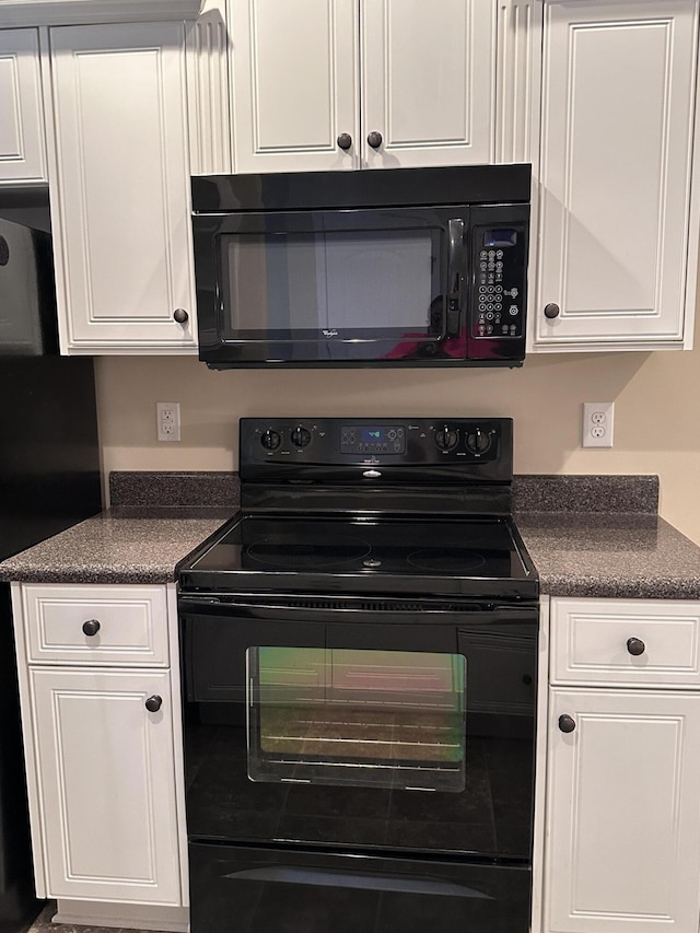 kitchen with black appliances and white cabinets