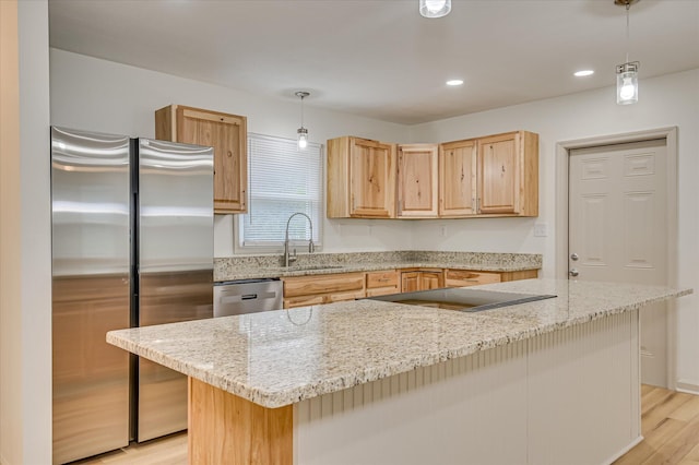 2426 Dickey Rd, Augusta, GA 30906 - kitchen featuring stainless steel appliances, light brown cabinets, light wood-style floors, light stone countertops, and pendant lighting