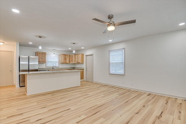 2426 Dickey Rd, Augusta, GA 30906 - kitchen featuring freestanding refrigerator, light wood-type flooring, ceiling fan, recessed lighting, and a center island