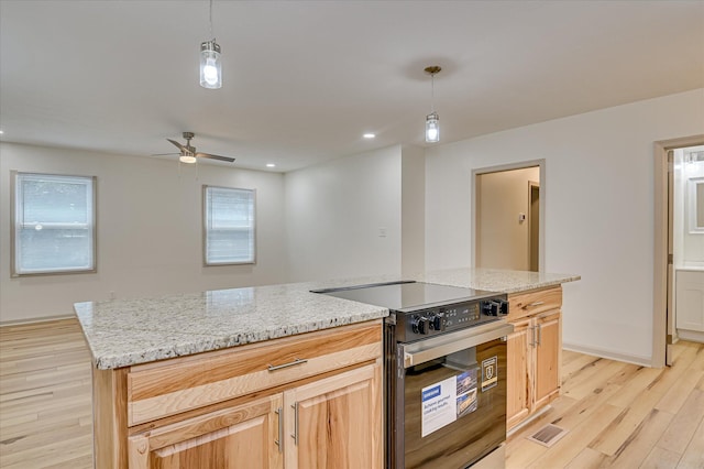 2426 Dickey Rd, Augusta, GA 30906 - kitchen featuring stainless steel range with electric stovetop, light wood-style floors, light stone counters, hanging light fixtures, and a ceiling fan