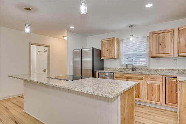 2426 Dickey Rd, Augusta, GA 30906 - kitchen featuring light brown cabinets, stainless steel appliances, a center island, light wood-type flooring, and light stone countertops