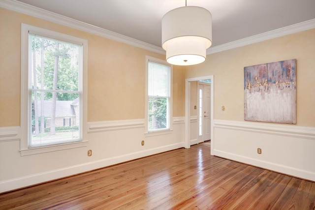 615 Stevens Xing, Augusta, GA 30907 - unfurnished room with wood finished floors, healthy amount of natural light, ornamental molding, and a wainscoted wall