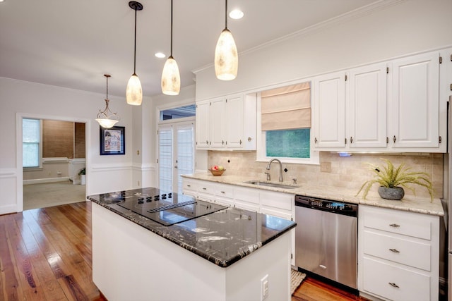 615 Stevens Xing, Augusta, GA 30907 - kitchen with stainless steel dishwasher, black electric cooktop, hardwood / wood-style flooring, decorative backsplash, and dark stone counters