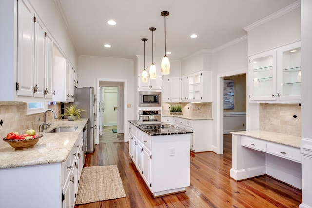 615 Stevens Xing, Augusta, GA 30907 - kitchen with appliances with stainless steel finishes, backsplash, white cabinetry, hardwood / wood-style flooring, and crown molding