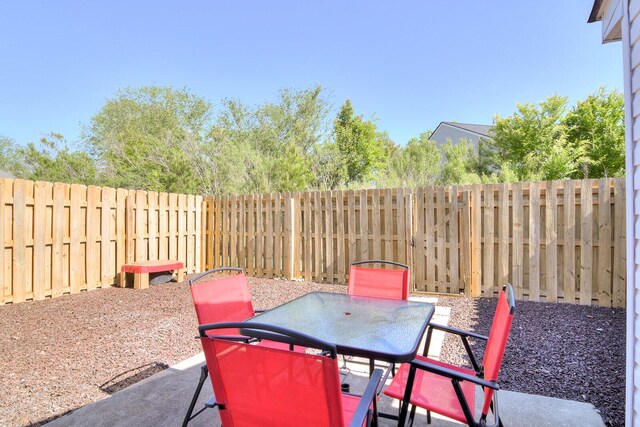 view of patio featuring a fenced backyard and outdoor dining area