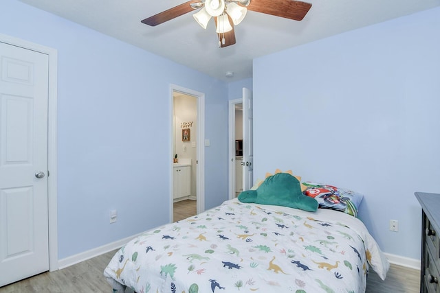 bedroom featuring baseboards, a ceiling fan, connected bathroom, and light wood-style floors