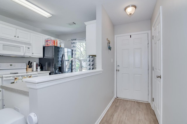 interior space with light wood-type flooring, baseboards, and visible vents