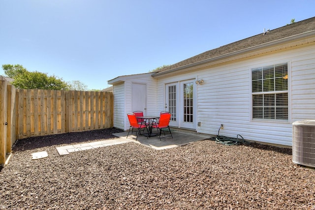view of patio with a fenced backyard and central AC