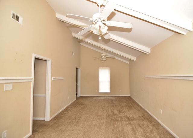 carpeted empty room featuring ceiling fan and lofted ceiling with beams