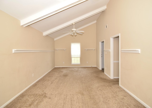 carpeted spare room with beam ceiling, ceiling fan, and high vaulted ceiling