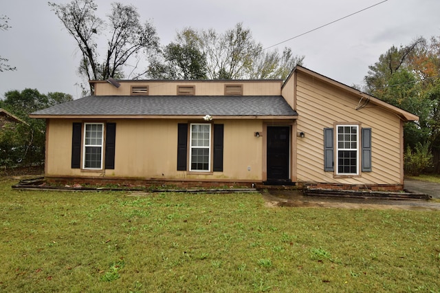 ranch-style home with a front lawn