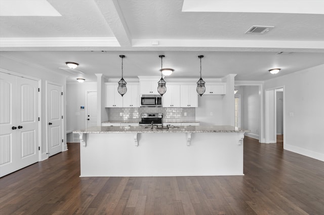 5174 Copse Dr, Augusta, GA 30909 - kitchen with appliances with stainless steel finishes, white cabinetry, backsplash, a breakfast bar area, and a spacious island