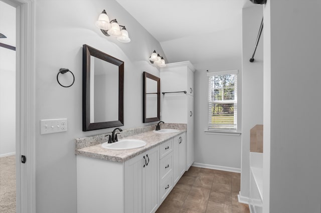 5174 Copse Dr, Augusta, GA 30909 - bathroom featuring double vanity, a tub, and lofted ceiling