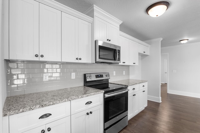 5174 Copse Dr, Augusta, GA 30909 - kitchen with appliances with stainless steel finishes, ornamental molding, decorative backsplash, light stone countertops, and dark wood-style flooring