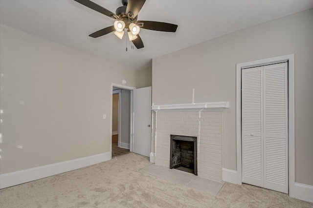 unfurnished living room with light carpet, a fireplace, baseboards, and a ceiling fan
