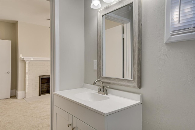 bathroom with a fireplace and vanity