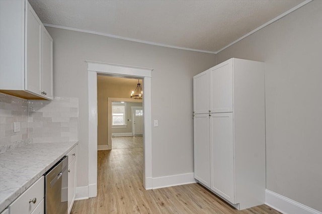 kitchen featuring light wood-style flooring, white cabinets, dishwasher, decorative backsplash, and a notable chandelier