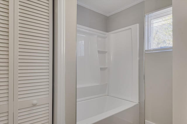 full bathroom featuring crown molding, baseboards, and bathtub / shower combination