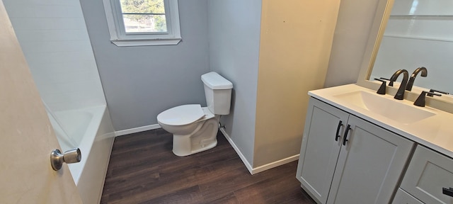 full bathroom featuring vanity, wood-type flooring,  shower combination, and toilet