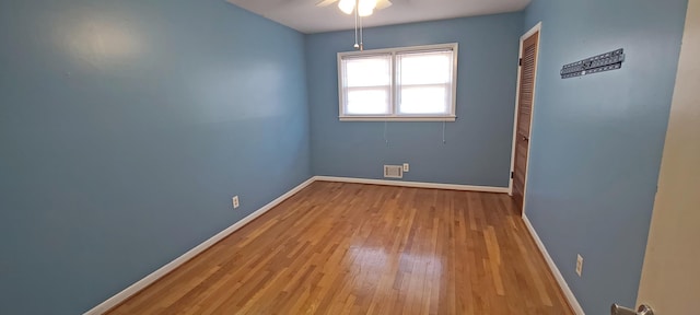 unfurnished room featuring ceiling fan and light wood-type flooring