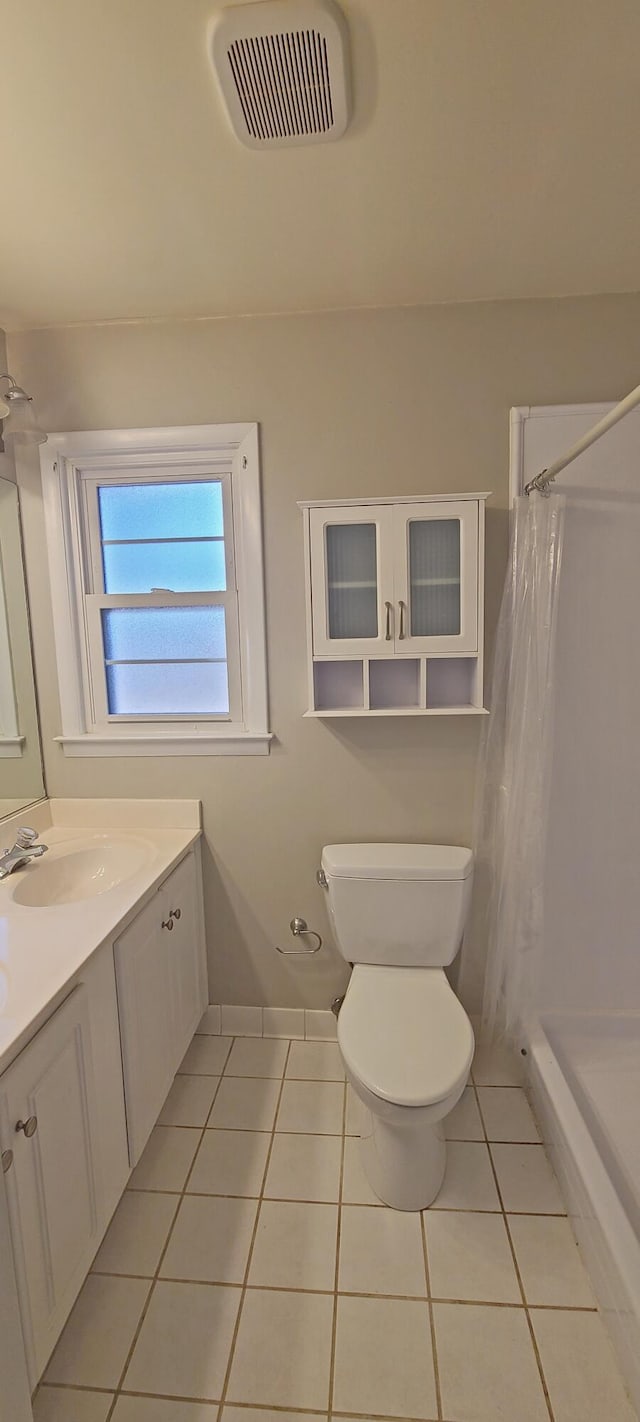 bathroom featuring tile patterned flooring, vanity, toilet, and a shower with shower curtain