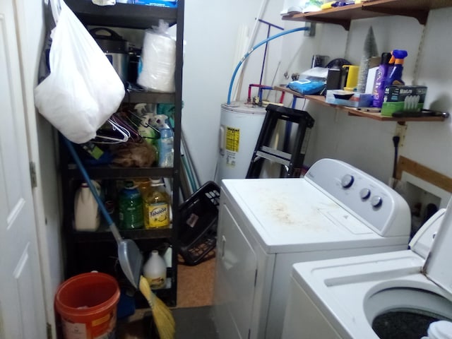 clothes washing area with washer and clothes dryer and water heater