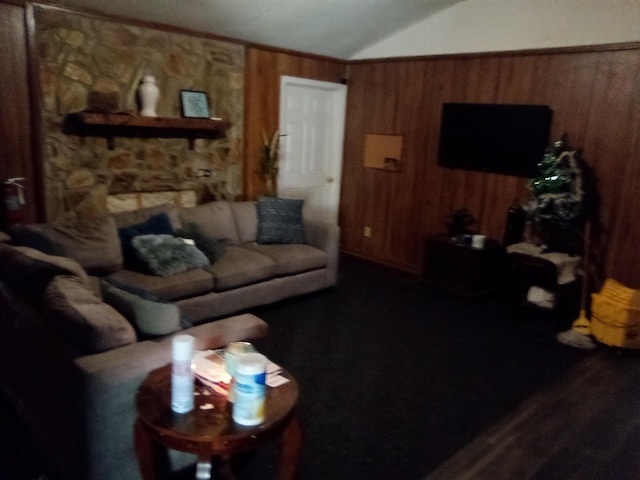 living room featuring vaulted ceiling and wood walls